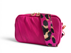 Hot pink leather, small crossbody bag with a matching leopard print strap on a white background