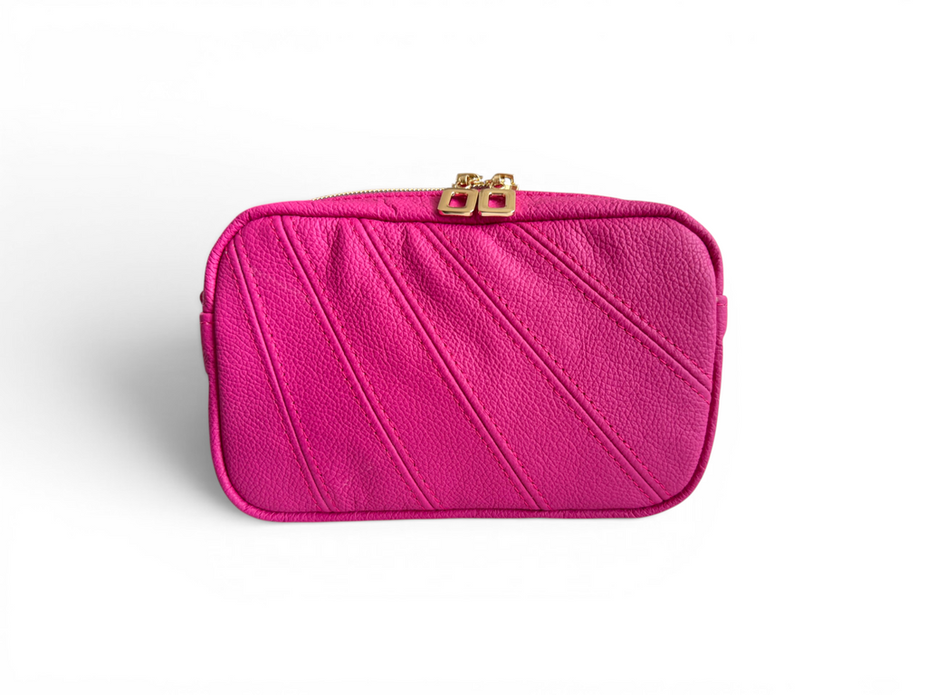 Front view of a fuschia pink leather clutch bag with a gold clasp on a white background