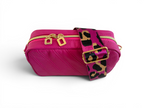 Hot pink leather smallcrossbody bag with gold zippers and a leopard print strap on a white background
