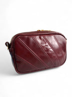 Maroon, real leather handbag on a white background