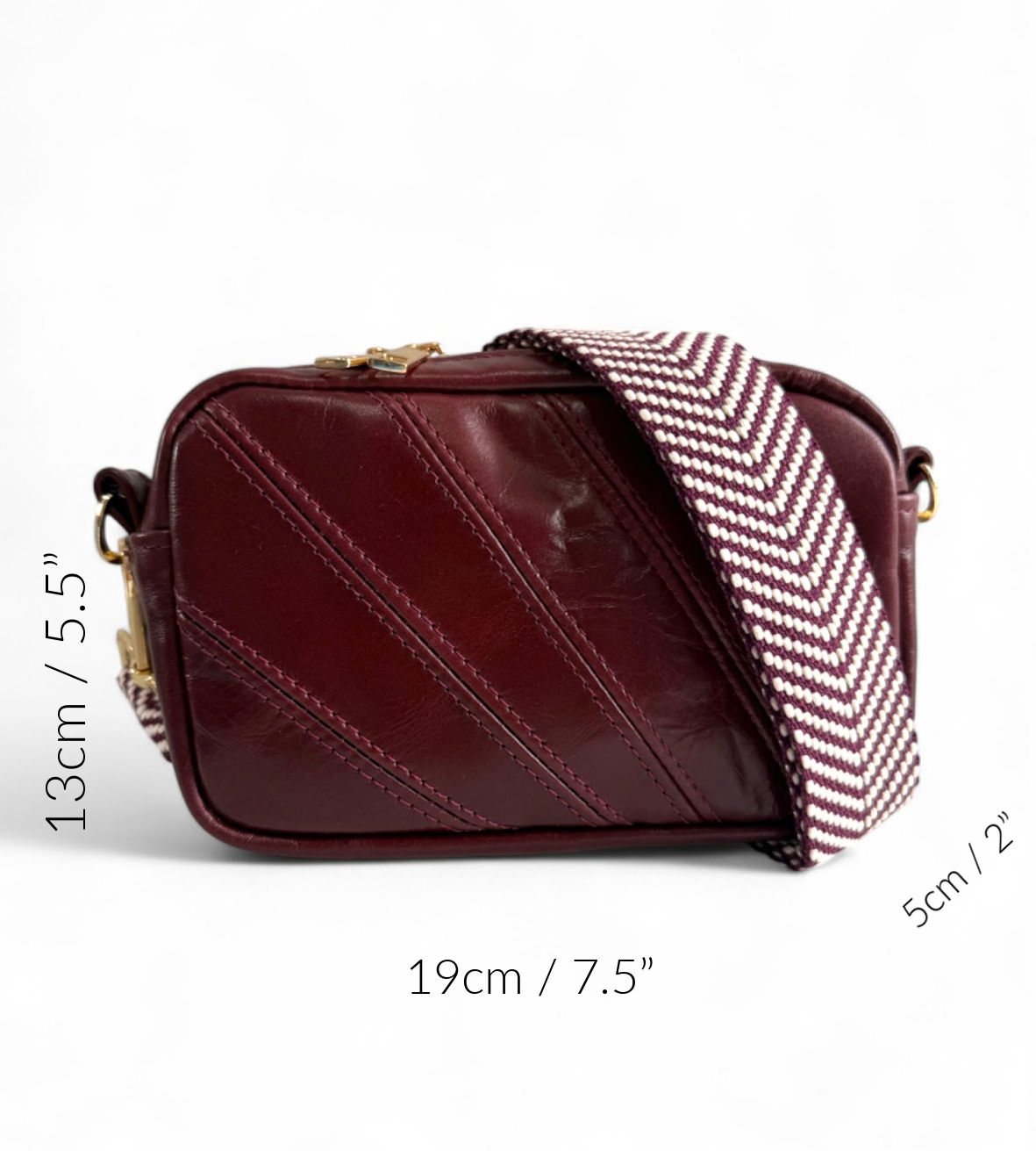 Maroon handbag with chevron patterned strap and measurement markings.