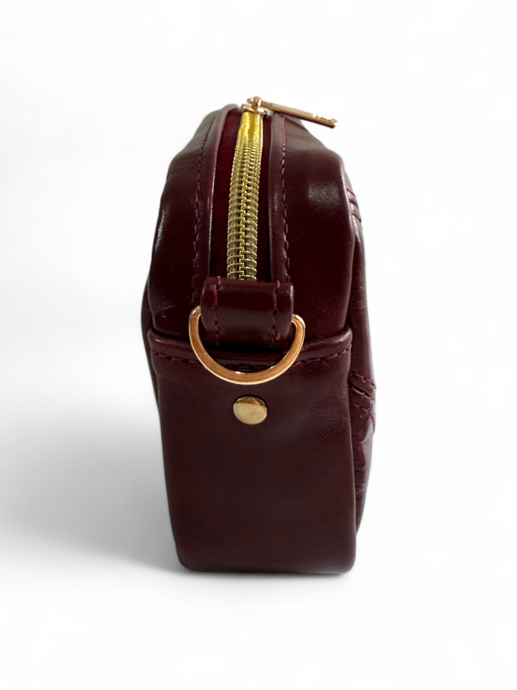 Maroon leather compact crossbody  bag with gold zipper and clasp on a white background