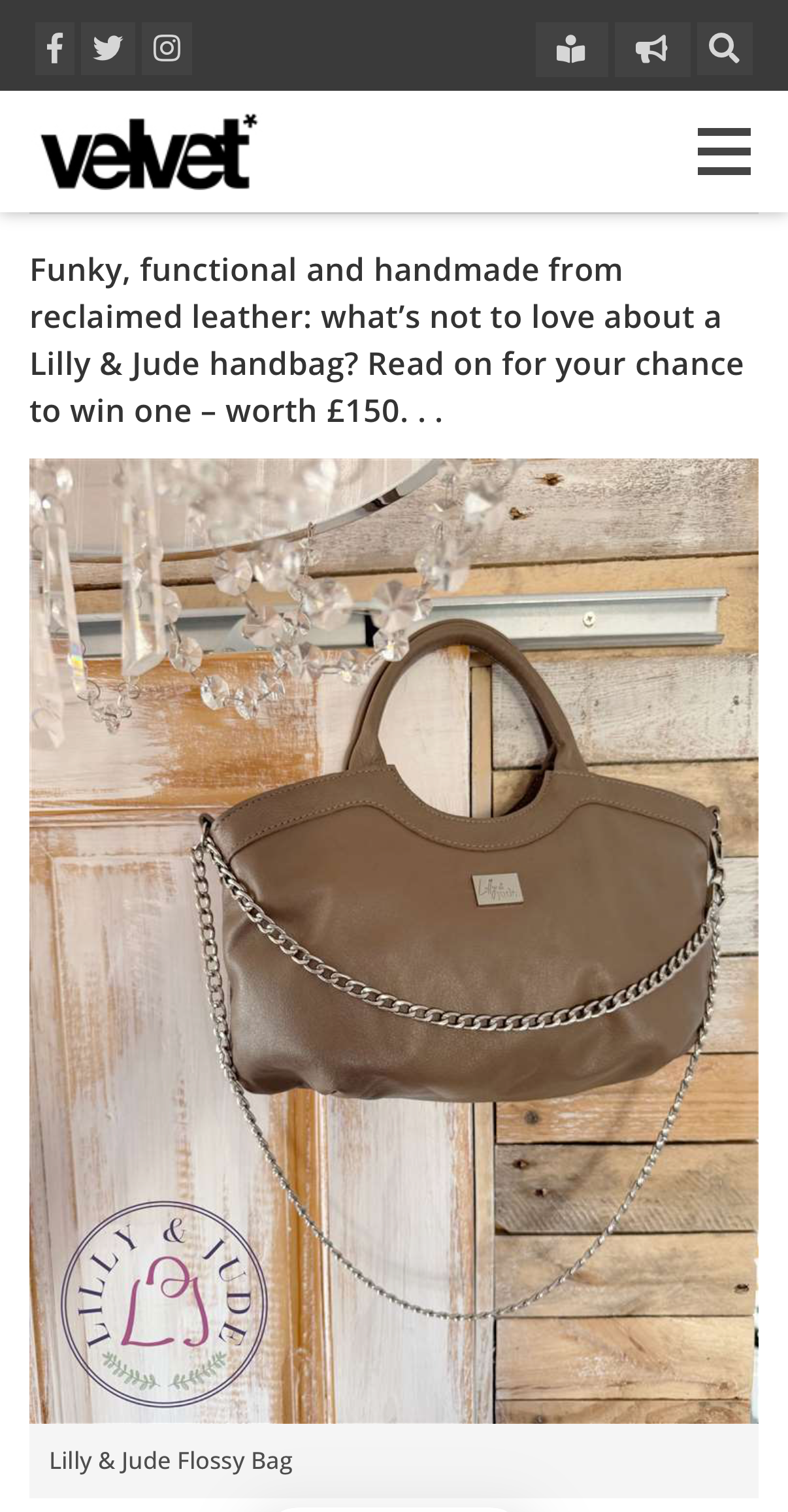 Screen grab from velvet magazine featture. The image shows the taupe leather handbag with silver chain and hardware, hanging on the edge of a wooden door, featuring the brand 'Lilly & Jude'.